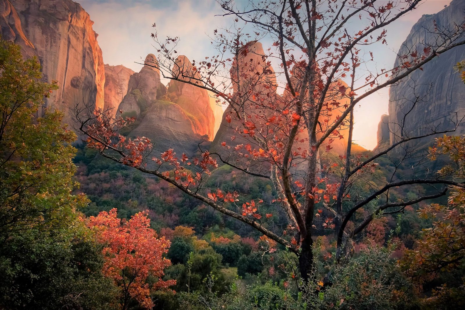 The Meteora rock pillars at dusk with a monastery on top of one of them